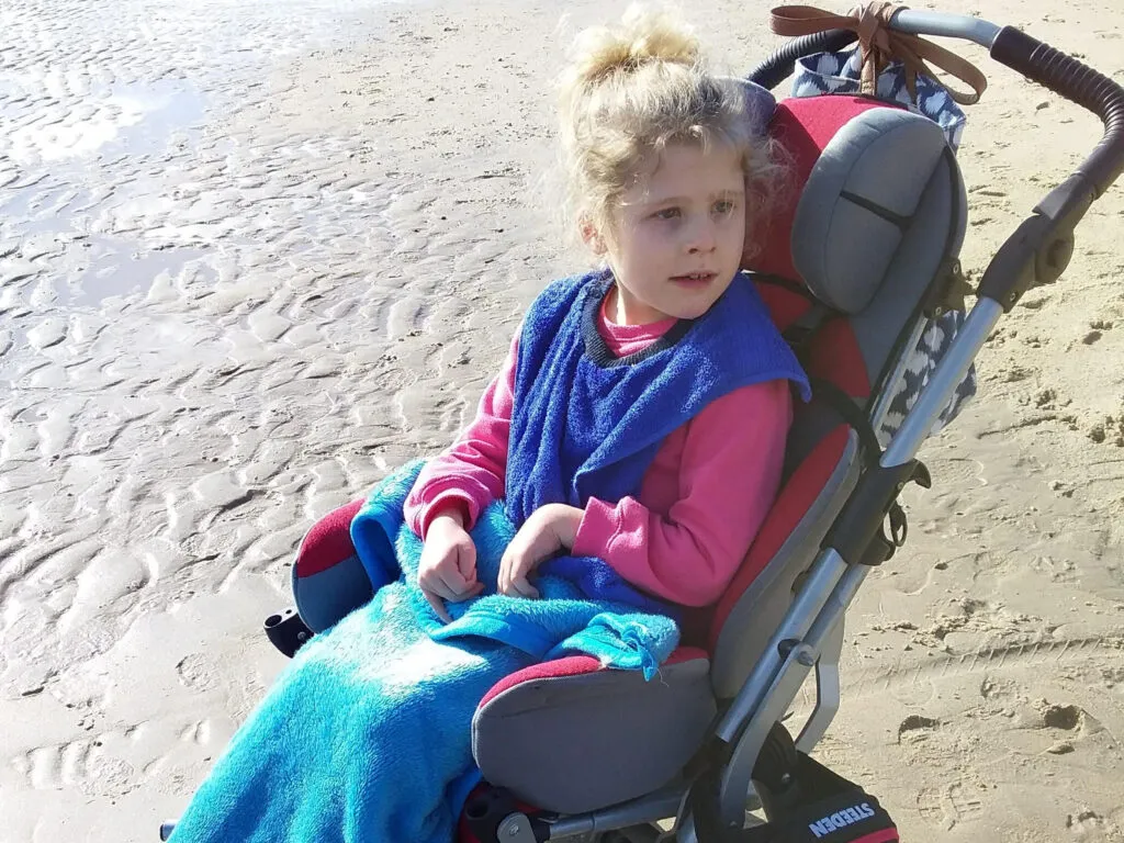 A child living with STXBP1 supported by their family.