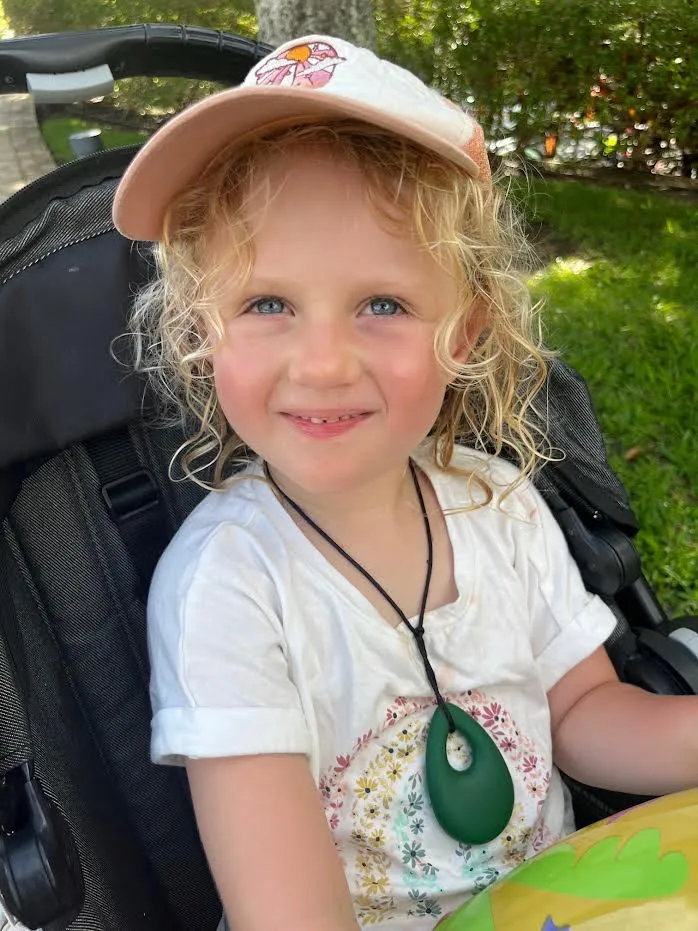 Ava, a young girl who lives with STXBP1, smiling.